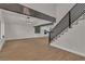 Spacious living room with a staircase, dark wood beam, and open access to the kitchen at 4061 W Eldorado Ln, Las Vegas, NV 89139
