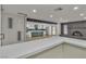 Spacious living room featuring modern open kitchen, brick fireplace and large windows overlooking the backyard at 4061 W Eldorado Ln, Las Vegas, NV 89139