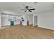 Bright living area featuring wood floors, modern appliances, and white cabinetry at 4061 W Eldorado Ln, Las Vegas, NV 89139