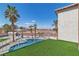 Backyard swimming pool and palm trees under a bright blue sky at 4061 W Eldorado Ln, Las Vegas, NV 89139