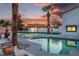 Inviting pool area enhanced with mature palm trees, offering a tranquil setting for relaxation and leisure at 4061 W Eldorado Ln, Las Vegas, NV 89139