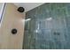 Updated shower with tile surround, rainfall shower head and modern fixtures at 4061 W Eldorado Ln, Las Vegas, NV 89139