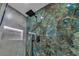 Modern shower with marble-style accent wall and matte black fixtures, adding a touch of elegance at 4061 W Eldorado Ln, Las Vegas, NV 89139