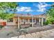 Exterior view of the home with a covered patio, desert landscaping, and a red tiled roof at 4617 Mancilla St, Las Vegas, NV 89130