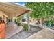 Inviting backyard featuring a covered patio, mature trees, and lush landscaping at 4617 Mancilla St, Las Vegas, NV 89130