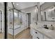 Beautiful bathroom with dual sinks, and shower over tub with clear glass door at 4617 Mancilla St, Las Vegas, NV 89130