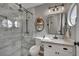 Modern bathroom with walk-in shower, custom vanity, and round accent window at 4617 Mancilla St, Las Vegas, NV 89130