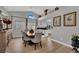 Bright dining room features vaulted ceilings, wood floors, and views of the kitchen at 4617 Mancilla St, Las Vegas, NV 89130