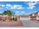 Charming single-story home with a two-car garage, mature palm trees, and desert landscaping at 4617 Mancilla St, Las Vegas, NV 89130