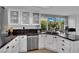 Modern kitchen with white cabinets, granite countertops, stainless steel appliances and natural light at 4617 Mancilla St, Las Vegas, NV 89130