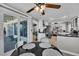 Bright kitchen features stainless steel appliances, white cabinetry, and sliding glass doors to outdoor patio at 4617 Mancilla St, Las Vegas, NV 89130