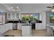 Bright kitchen showcases white cabinetry, granite countertops, stainless appliances, and a beverage cooler at 4617 Mancilla St, Las Vegas, NV 89130