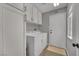 Functional laundry room with washer, dryer, white cabinets, and tiled flooring at 4617 Mancilla St, Las Vegas, NV 89130