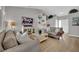 Open-concept living room with neutral decor and hardwood flooring at 4617 Mancilla St, Las Vegas, NV 89130