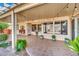 Spacious covered patio area with tiled flooring, decorative plants, and outdoor lighting at 4617 Mancilla St, Las Vegas, NV 89130