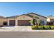 Charming single-story home with a three-car garage, well-maintained landscaping, and a welcoming curb appeal at 4937 Semifonte Dr, Pahrump, NV 89061