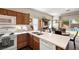 Functional kitchen featuring white countertops, wooden cabinets, and a view of the backyard pool at 4937 Semifonte Dr, Pahrump, NV 89061