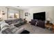 Comfortable living room featuring a sectional sofa, television, and neutral tones for a relaxing ambiance at 4937 Semifonte Dr, Pahrump, NV 89061