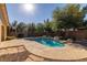Beautiful backyard pool featuring a rock waterfall, mature trees, and privacy at 4937 Semifonte Dr, Pahrump, NV 89061