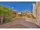 Large backyard with minimal landscaping featuring a brick patio and small garden areas at 5080 Plymouth Bay Ct, Las Vegas, NV 89141