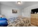 Bright bedroom featuring neutral decor, comfortable bed, and practical wooden storage at 5080 Plymouth Bay Ct, Las Vegas, NV 89141