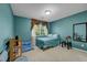 Calm bedroom featuring soft blue walls, carpet, and a comfortable futon for extra seating at 5080 Plymouth Bay Ct, Las Vegas, NV 89141