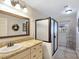 Well-lit bathroom featuring a stylish vanity, glass shower and modern fixtures at 5159 N Monte Cristo Way, Las Vegas, NV 89149