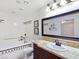 Bright bathroom features a bathtub, granite countertop and a decorative mirror and lighting fixture at 5159 N Monte Cristo Way, Las Vegas, NV 89149