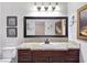 Stylish bathroom features a granite countertop, modern fixtures and large mirror at 5159 N Monte Cristo Way, Las Vegas, NV 89149