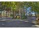 Long driveway with lush greenery and towering trees creating a private and inviting entrance at 5159 N Monte Cristo Way, Las Vegas, NV 89149