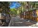 Long driveway, complemented by art, leading to the home and surrounded by mature trees at 5159 N Monte Cristo Way, Las Vegas, NV 89149