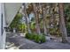 A covered walkway and landscaped garden featuring paved flooring and mature trees at 5159 N Monte Cristo Way, Las Vegas, NV 89149