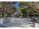 Charming single-story home with a decorative white fence, mature trees, and stone accents at 5159 N Monte Cristo Way, Las Vegas, NV 89149