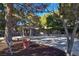 Single-story stone home features double door entry, mature trees, and a wide driveway at 5159 N Monte Cristo Way, Las Vegas, NV 89149