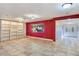 Spacious living room with built-in shelving, tile flooring, and a view of the home's entry at 5159 N Monte Cristo Way, Las Vegas, NV 89149
