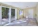 Bright living room featuring tile floors, large windows, and access to the outdoor patio at 5159 N Monte Cristo Way, Las Vegas, NV 89149