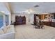 Spacious living room with tile flooring, bright lighting, with an adjacent kitchen and dining area at 5159 N Monte Cristo Way, Las Vegas, NV 89149