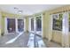 Bright living room featuring tile floors, large windows, and access to the outdoor patio at 5159 N Monte Cristo Way, Las Vegas, NV 89149