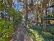 A charming pathway through a tranquil forest, perfect for a peaceful walk in nature at 5159 N Monte Cristo Way, Las Vegas, NV 89149