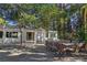 A furnished outdoor patio featuring paved flooring, mature trees, and access to the main house at 5159 N Monte Cristo Way, Las Vegas, NV 89149