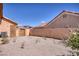 A gravel-covered backyard with minimal landscaping and a small storage shed at 5441 Rose Hills St, Las Vegas, NV 89149