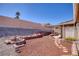 Backyard with a rock garden and brick-lined walkway leading to a covered patio at 5441 Rose Hills St, Las Vegas, NV 89149
