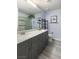 Bathroom featuring a long vanity with double sinks, and a glass enclosed walk-in shower at 5441 Rose Hills St, Las Vegas, NV 89149