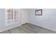Empty bedroom with wood-look floors, window with blinds, neutral paint and closet at 5441 Rose Hills St, Las Vegas, NV 89149