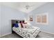 Bright bedroom features wood-look floors, window with blinds, neutral paint, and simple decor at 5441 Rose Hills St, Las Vegas, NV 89149