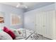 Bedroom with white ceiling fan, window with blinds, neutral paint, and closet at 5441 Rose Hills St, Las Vegas, NV 89149