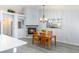 Dining area with wood table and chairs adjacent to the kitchen, with a view of the fireplace and a large mirror on the wall at 5441 Rose Hills St, Las Vegas, NV 89149