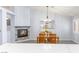 Bright dining area features a decorative chandelier, wood table, and a view of the fireplace and kitchen through a mirror at 5441 Rose Hills St, Las Vegas, NV 89149