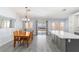 Open dining area featuring gray floors, bright lighting, and seamless access to the backyard at 5441 Rose Hills St, Las Vegas, NV 89149