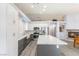 Bright kitchen features white cabinets, stainless steel appliances, subway tile backsplash, and a gray island with a marble countertop at 5441 Rose Hills St, Las Vegas, NV 89149